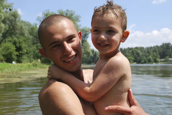 Father and son swimming in the river. — Stock Photo, Image