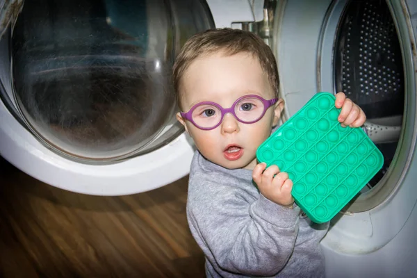 Little Boy Glasses Plays Room Washing Machine Throws Toys — Stock Photo, Image