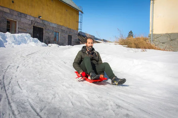 Bright Sunny Day Winter Man Slides Slope Red Plastic Sled — Stock Photo, Image