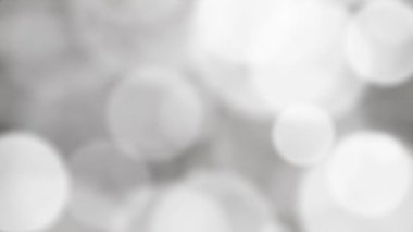 Soyut hareket eden gümüş ve beyaz bokeh ışıkları hareketli grafikler arka plan, 4k yavaş çekim animasyonu