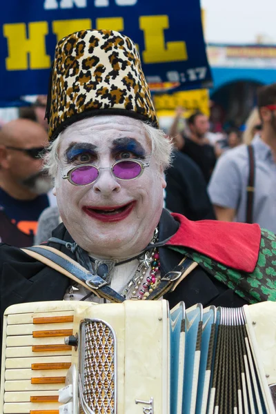 Mann mit geschminktem Gesicht und Akkordeonspiel beim 37. Wagenfest — Stockfoto