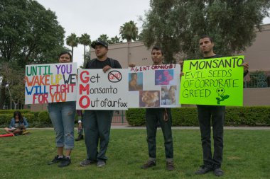 Protesters rallied in the streets against the Monsanto corporation clipart