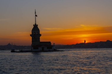 İstanbul, Türkiye 'nin sembolü Leander' s Tower olarak da bilinen ünlü Maiden 's Tower (Kiz Kulesi) ile Boğaz' ın üzerinde kızgın bir günbatımı. Duvar kağıdı veya rehber kitap için sahne yolculuğu arkaplanı