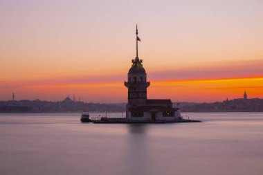 İstanbul, Türkiye 'nin sembolü Leander' s Tower olarak da bilinen ünlü Maiden 's Tower (Kiz Kulesi) ile Boğaz' ın üzerinde kızgın bir günbatımı. Duvar kağıdı veya rehber kitap için sahne yolculuğu arkaplanı