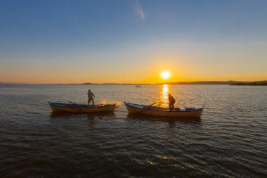Gün batımında göl balıkçısı