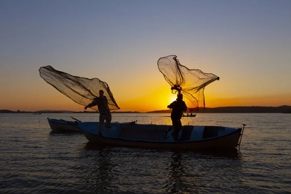 Gün batımında göl balıkçısı