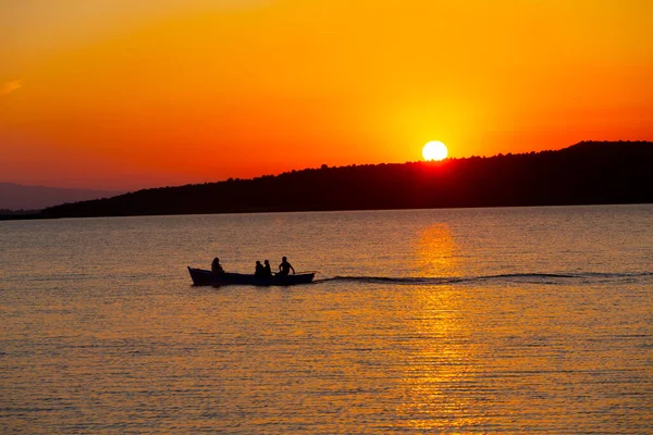 Gün batımında göl balıkçısı