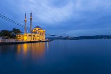 Istanbul. Image of Ortakoy Mosque with Bosphorus Bridge in Istanbul during beautiful sunrise.
