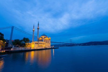 Istanbul. Image of Ortakoy Mosque with Bosphorus Bridge in Istanbul during beautiful sunrise.