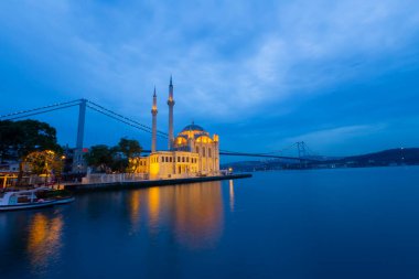 Istanbul. Image of Ortakoy Mosque with Bosphorus Bridge in Istanbul during beautiful sunrise.