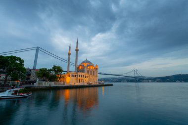 Istanbul. Image of Ortakoy Mosque with Bosphorus Bridge in Istanbul during beautiful sunrise.