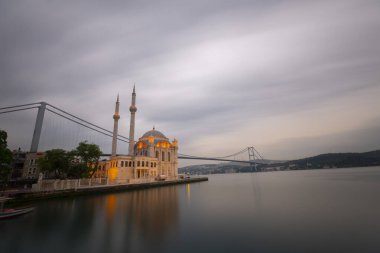 Istanbul. Image of Ortakoy Mosque with Bosphorus Bridge in Istanbul during beautiful sunrise.