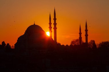 Günbatımı İstanbul, Türkiye 'de Süleyman Camii (Osmanlı İmparatorluğu Camii) ile birlikte. İstanbul 'daki Galata Köprüsü' nden görüntü.