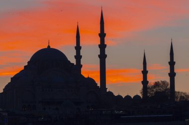 Günbatımı İstanbul, Türkiye 'de Süleyman Camii (Osmanlı İmparatorluğu Camii) ile birlikte. İstanbul 'daki Galata Köprüsü' nden görüntü.