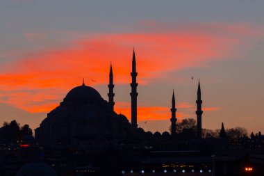 Günbatımı İstanbul, Türkiye 'de Süleyman Camii (Osmanlı İmparatorluğu Camii) ile birlikte. İstanbul 'daki Galata Köprüsü' nden görüntü.