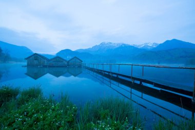 Almanya 'da gün batımında Bavyera Alplerinde sonbahar renklerinde güzel Kochelsee (Kochel Gölü)