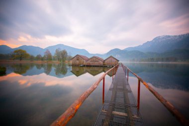 Beautiful Kochelsee (Kochel lake) in Bavaria in autumn colors in the Bavarian Alps at sunset in Germany