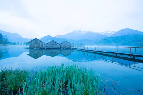 Almanya 'da gün batımında Bavyera Alplerinde sonbahar renklerinde güzel Kochelsee (Kochel Gölü)
