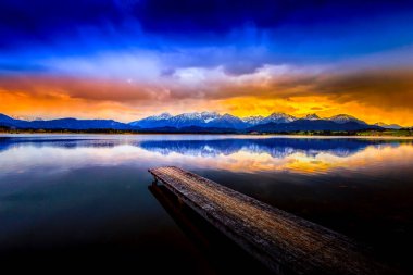 View over Hopfensee lake and the Alps. Bavaria, Germany, Europe.