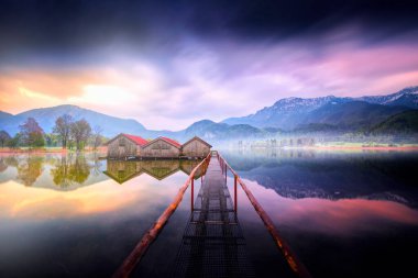 View of typical old boat houses at the Alpine lake Kochelsee in Bavaria