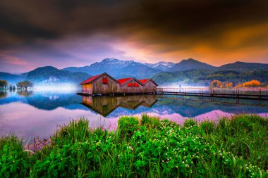 View of typical old boat houses at the Alpine lake Kochelsee in Bavaria