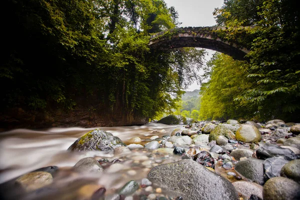 Old stone bridges and people passing by
