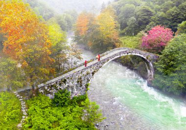 Old stone bridges and people passing by