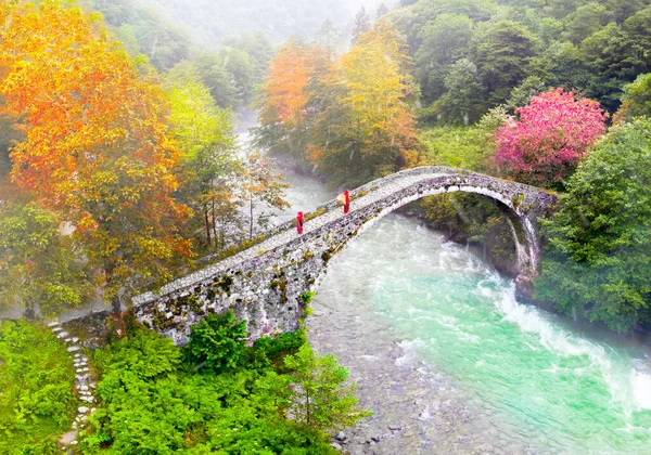 Old stone bridges and people passing by