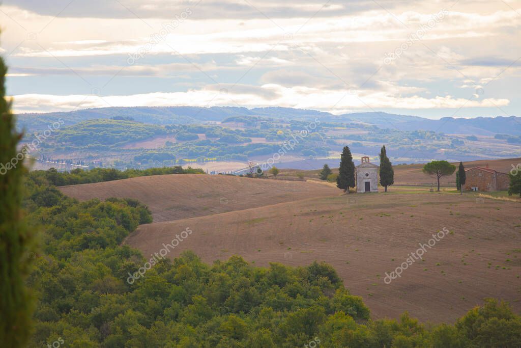Tuscany landscape at sunrise with a little chapel of Madonna di Vitaleta, San Quirico d'Orcia, Italy