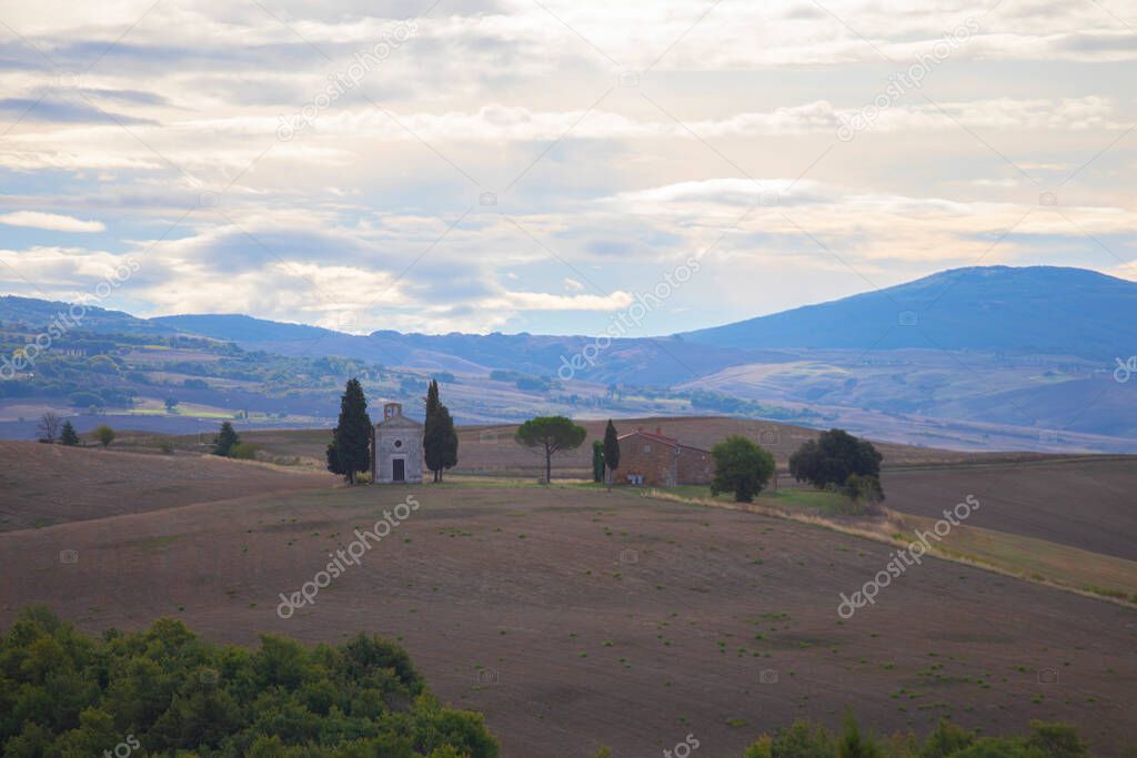 Tuscany landscape at sunrise with a little chapel of Madonna di Vitaleta, San Quirico d'Orcia, Italy