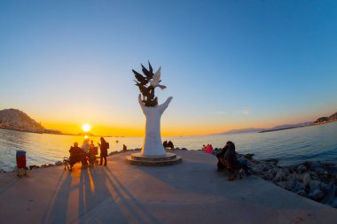 Hand of peace sculpture with doves on the waterfront in Kusadasi.