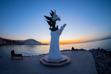 Kusadasi rıhtımında güvercinli barış heykeli..