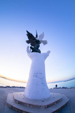 Kusadasi rıhtımında güvercinli barış heykeli..