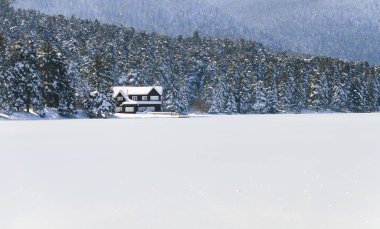 Lake wooden house on a snowy winter day in the forest in Bolu Glck National Park, Turkey , Panorama shot
