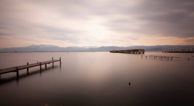 A collection of old piers was photographed using the long exposure technique