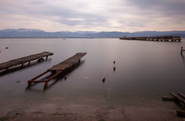 A collection of old piers was photographed using the long exposure technique