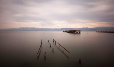 A collection of old piers was photographed using the long exposure technique