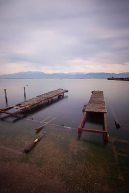 A collection of old piers was photographed using the long exposure technique
