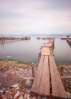 A collection of old piers was photographed using the long exposure technique