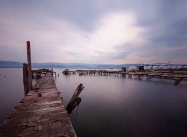 A collection of old piers was photographed using the long exposure technique