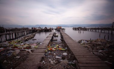 A collection of old piers was photographed using the long exposure technique