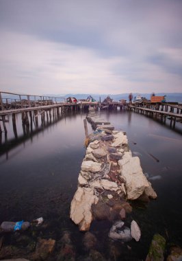A collection of old piers was photographed using the long exposure technique