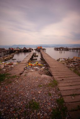 A collection of old piers was photographed using the long exposure technique