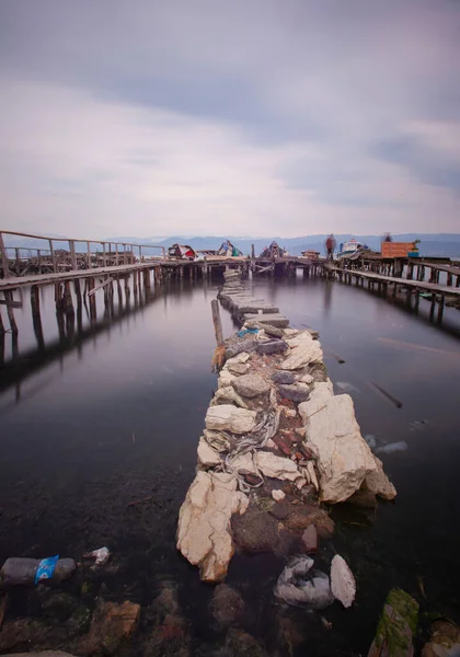 A collection of old piers was photographed using the long exposure technique