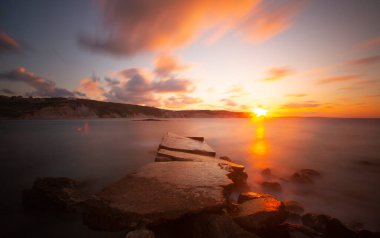 Photos taken with big rocks and long exposure technique at sunset