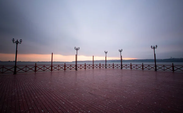 Aesthetic pier photographed with long exposure technique at sunset