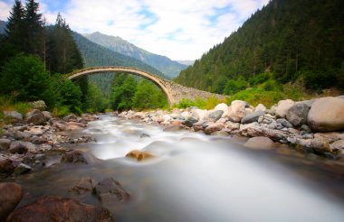 Daytime long exposure with neutral density filter of Firtina Creek and Historical Ottoman Stone Bridge. Kakar Mountains National Park, Rize, Turkey