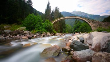 Daytime long exposure with neutral density filter of Firtina Creek and Historical Ottoman Stone Bridge. Kakar Mountains National Park, Rize, Turkey