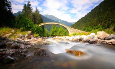 Daytime long exposure with neutral density filter of Firtina Creek and Historical Ottoman Stone Bridge. Kakar Mountains National Park, Rize, Turkey