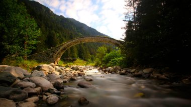 Daytime long exposure with neutral density filter of Firtina Creek and Historical Ottoman Stone Bridge. Kakar Mountains National Park, Rize, Turkey